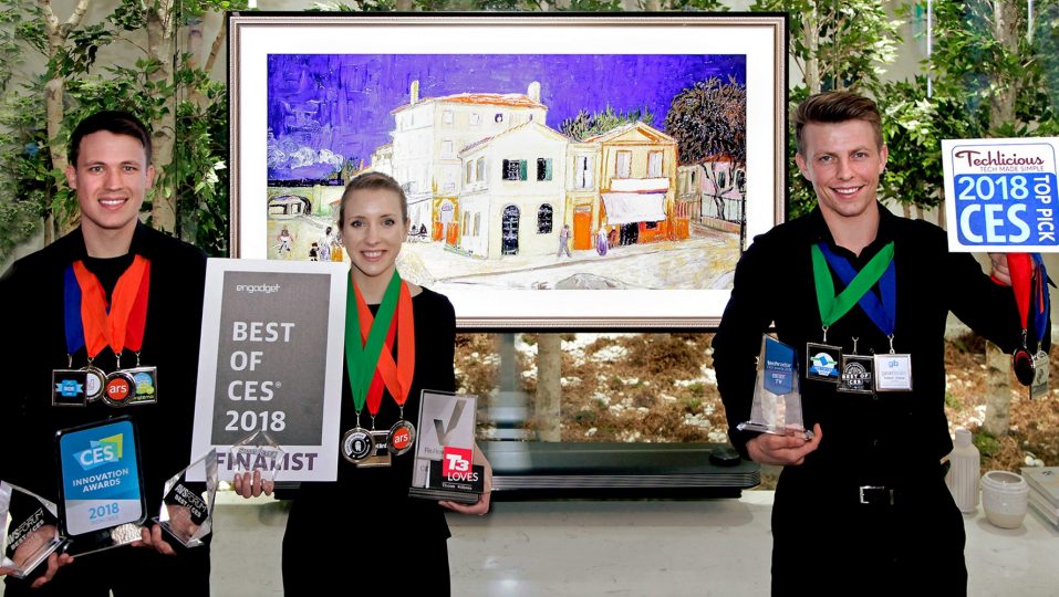 Models pose with the awards from Engadget, T3, Techlicious and more after LG won Best TV product honors at CES 2018.
