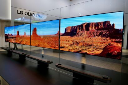 Another view of four LG SIGNATURE OLED TV W sets placed side by side on a display stand at LG's booth