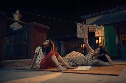 A screenshot of LG India’s “Astronaut” video, there are two women looking up towards the night sky