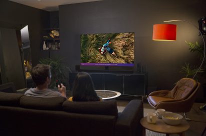 A couple experiencing the LG ThinQ Cinema Mode in their living room