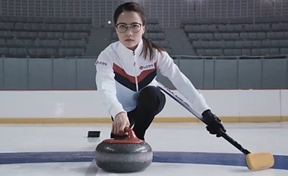 Skip Kim Eun-jung launches a stone with a broom in her left hand.