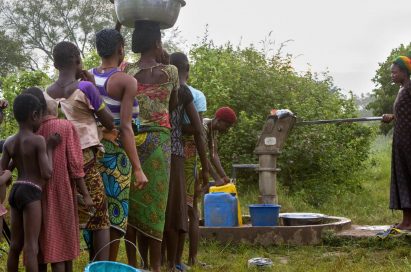 People wait in line to fetch the water from the public well.