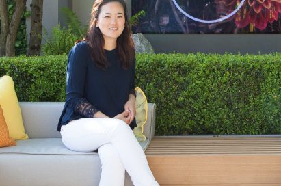 Korean landscape architect Hwang Hay-joung sits on a couch in front of the RHS Chelsea Flower Show logo.