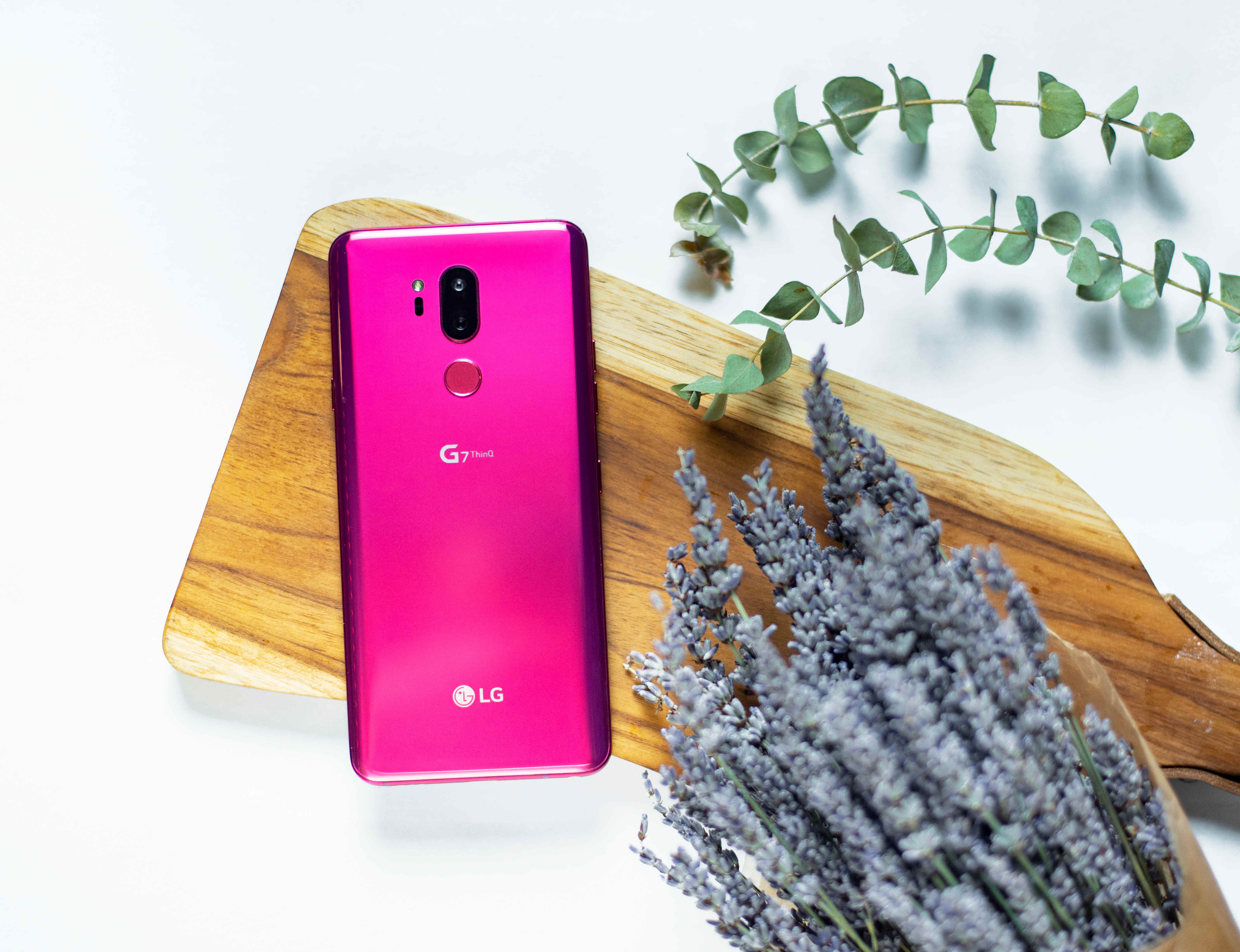 The LG G7 ThinQ in Raspberry Rose face down on a cutting board
