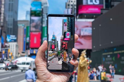 A person taking a photo of Times Square in New York with AI CAM on the LG G7 ThinQ