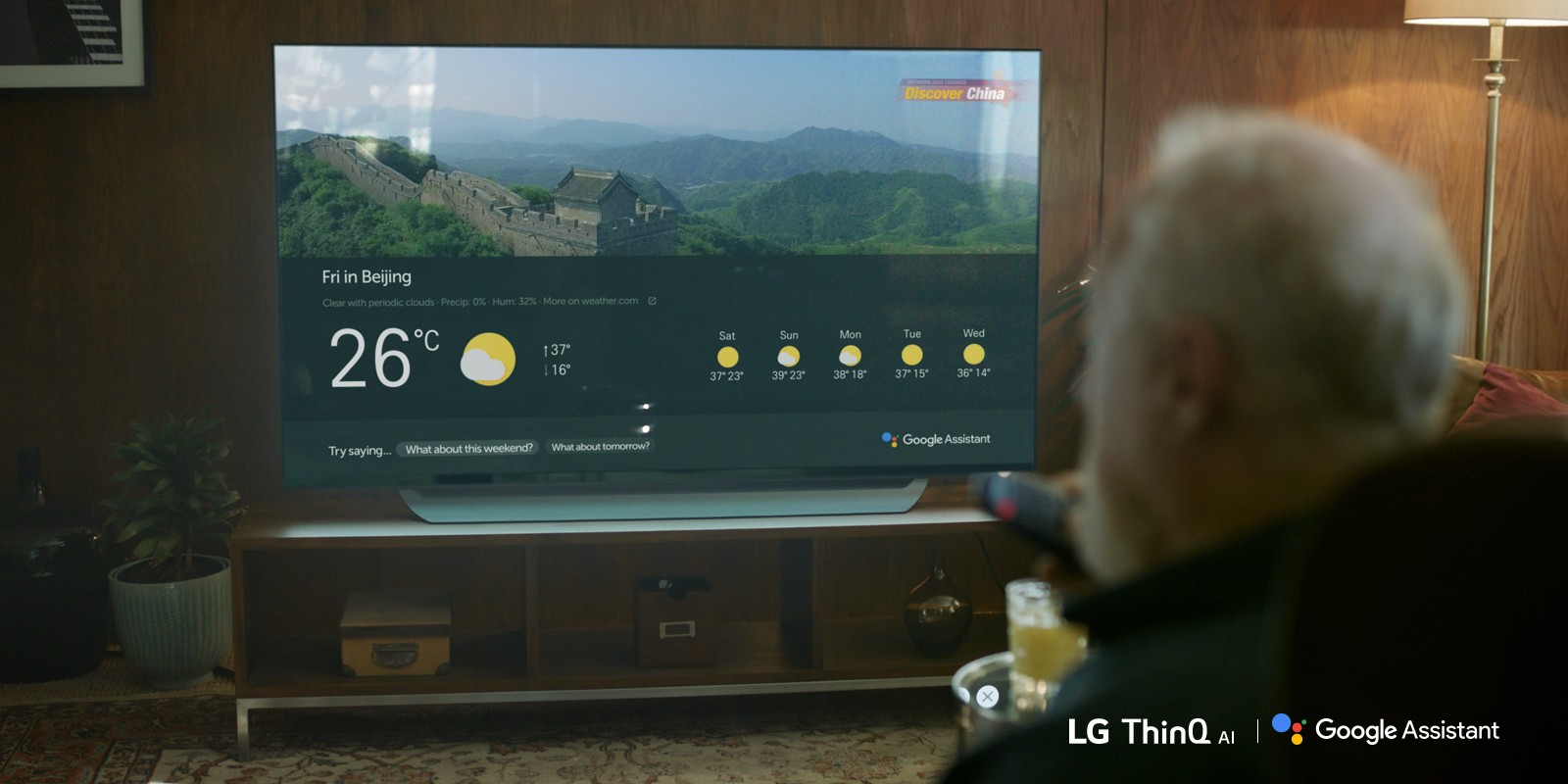 An elderly man checks the weather on his AI-enabled LG TV