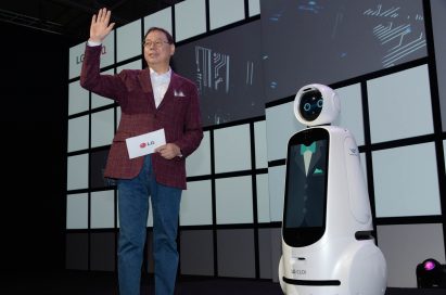 LG Electronics chief executive officer, Jo Seong-jin, stands right next to the LG CLOi robot.