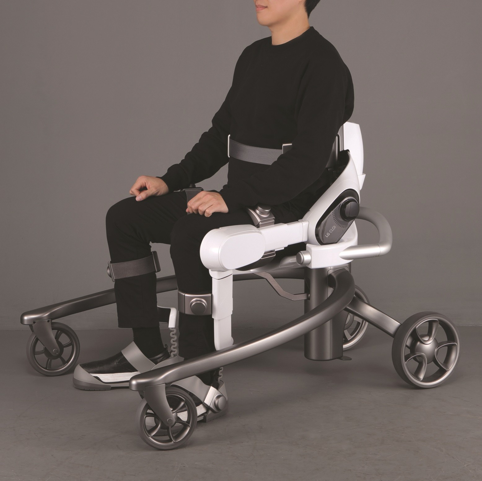 Side view of man seated on LG CLOi SuitBot