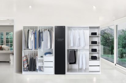 LG Styler with two doorless closests full of clothes on either side in a large living room