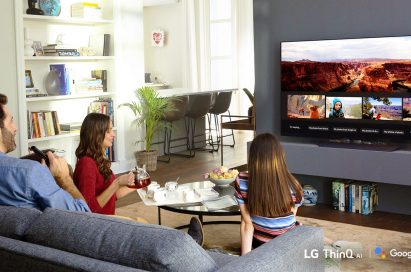 A family watching an LG TV using Google Assistant in their living room