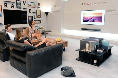 Models pose with LG ThinQ AI TV at the LG booth at IFA 2018.