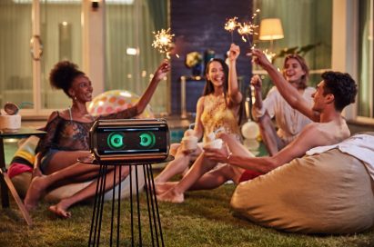 Young people throwing a party with the LG XBOOM Go on the table