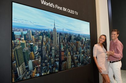 Two models look in awe at the world’s first LG 8K OLED TV displayed at IFA 2018