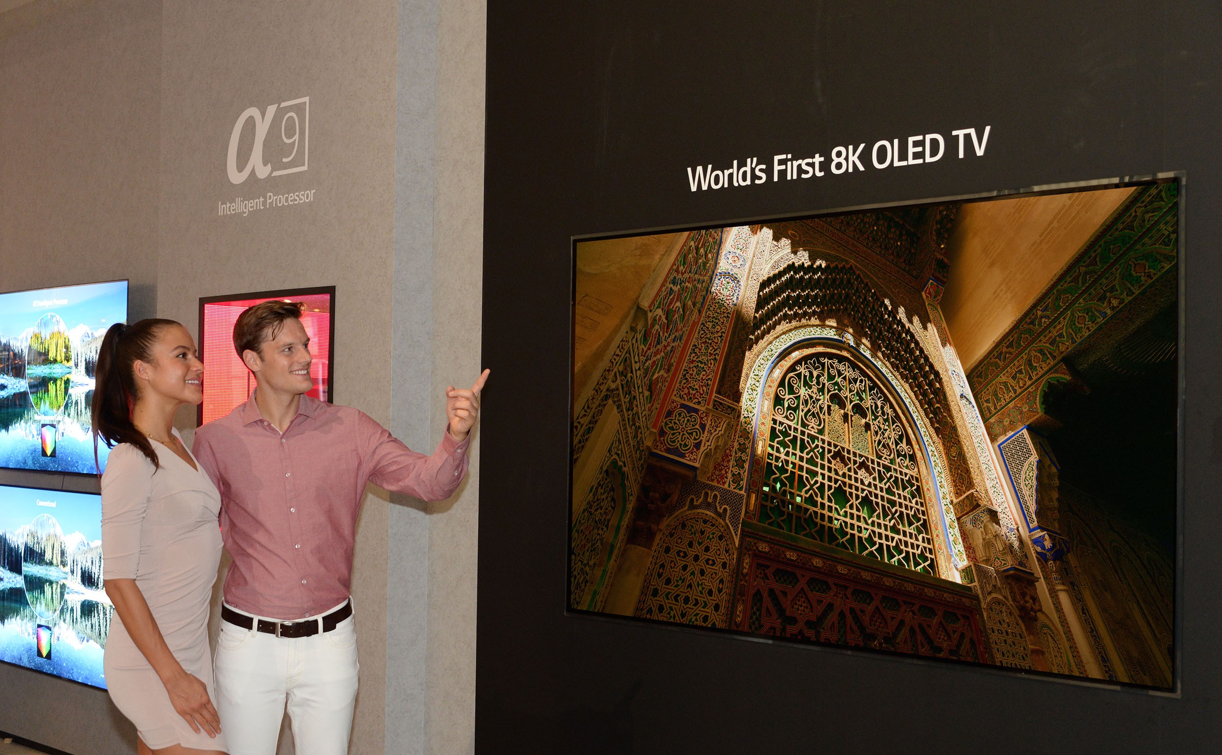 Two models admiring the world’s first LG 8K OLED TV at IFA 2018