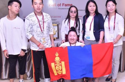 A group photo of the Mongolian participants holding up their national flag