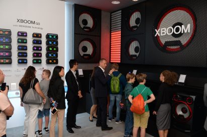 Visitors look at the products of LG XBOOM GO lineup which offers Meridian's premium sound.