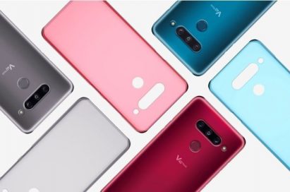 Three LG V40 ThinQs face down on a table with back cases positioned in a brick pattern.