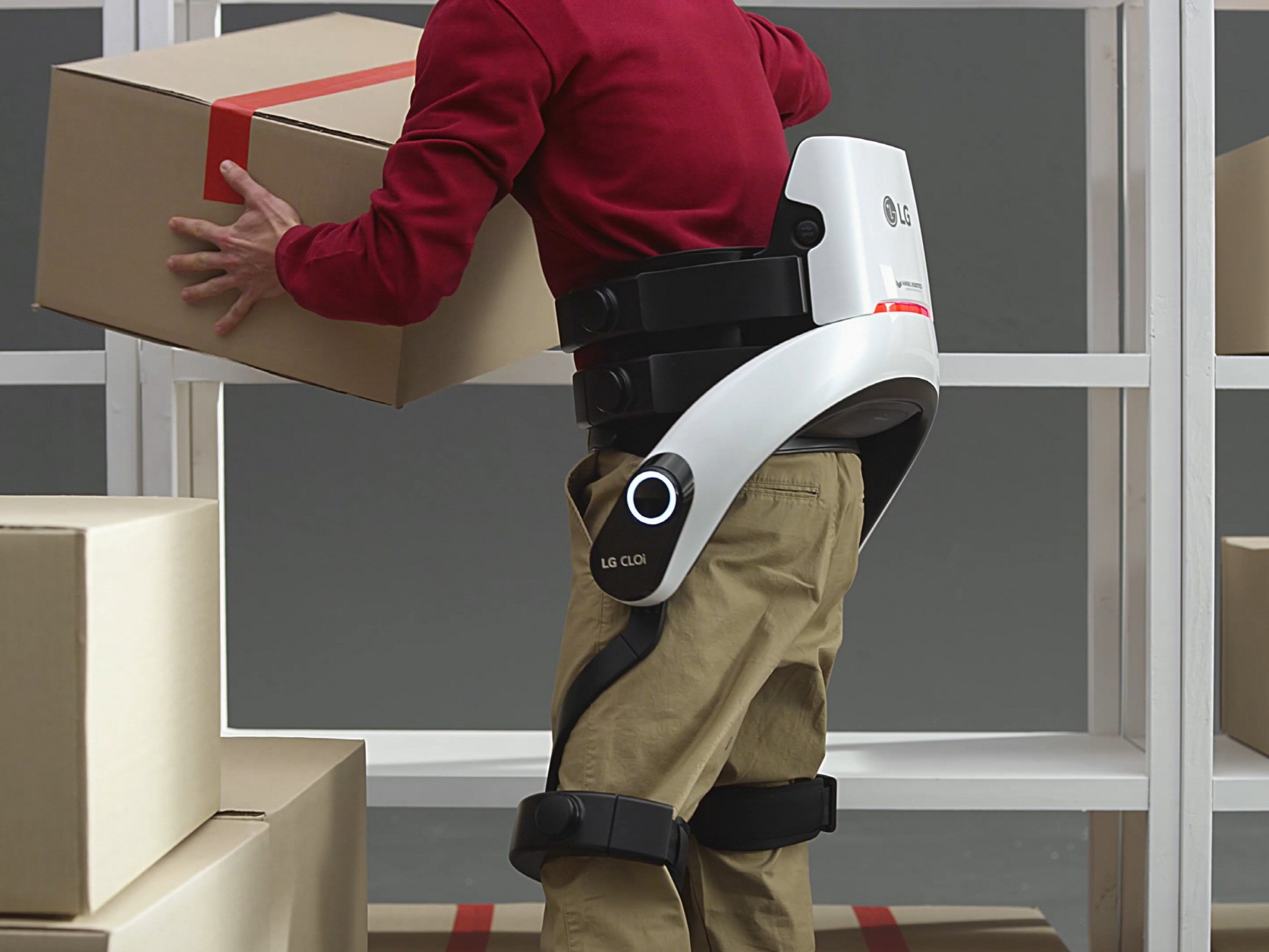 Close up of man lifting box while wearing the LG CLOi SuitBot