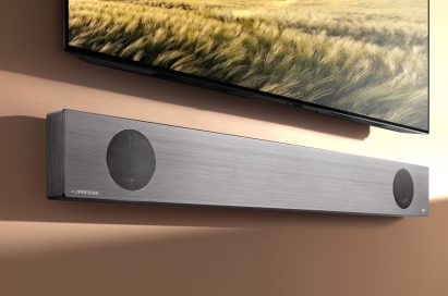 LG Soundbar model SL9YG fixed to a wall below an LG TV