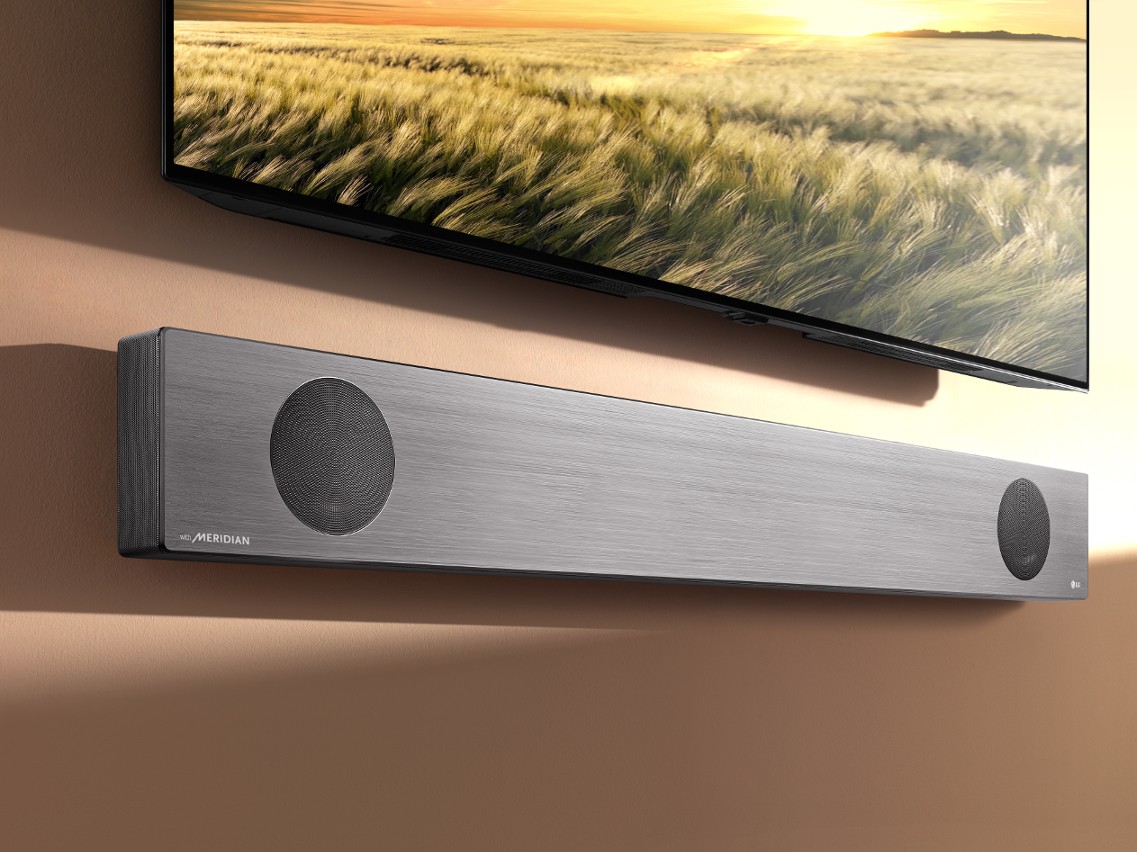 LG Soundbar model SL9YG fixed to a wall below an LG TV