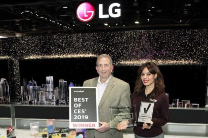 LG representatives pose with awards from Engadget, HD Guru and Reviewed.com