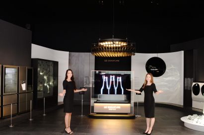 Two female models open their arms up to invite people to the LG SIGNATURE brand zone.