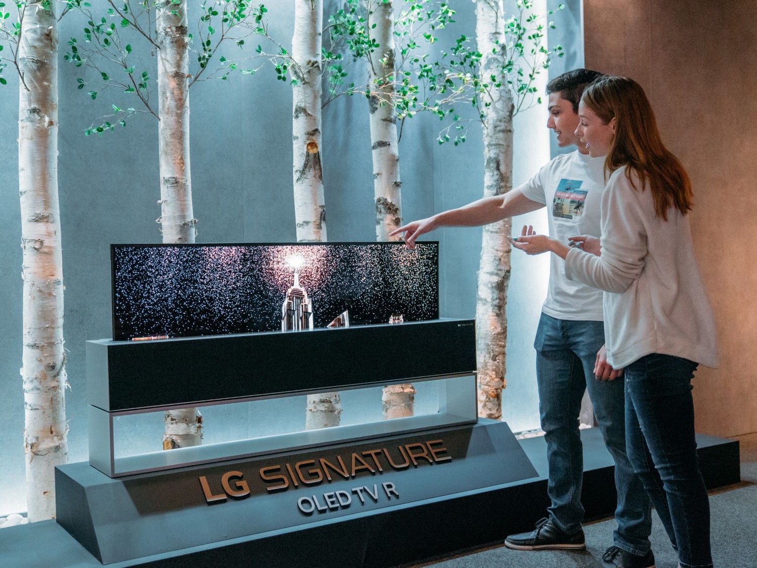 Models pose with LG SIGNATURE OLED TV R.
