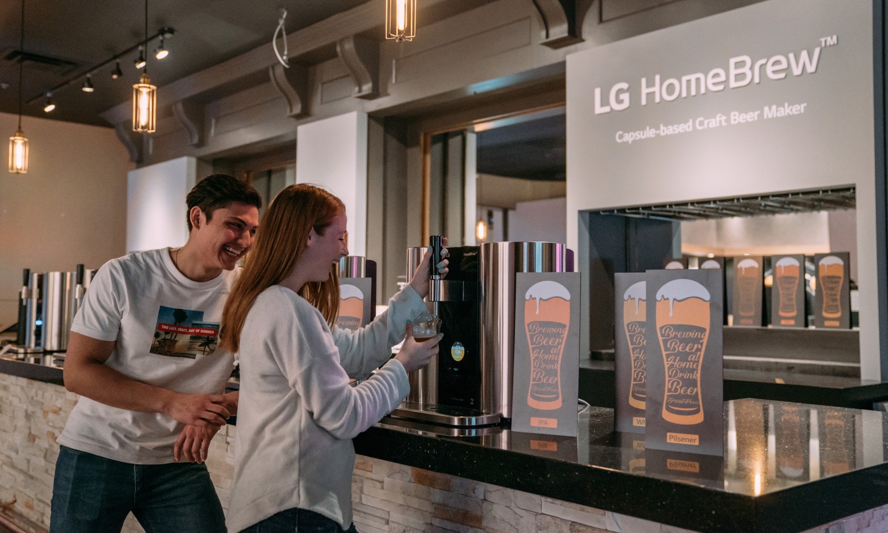 Models pose with LG HomeBrew, the innovative capsule-based device to make craft beer.