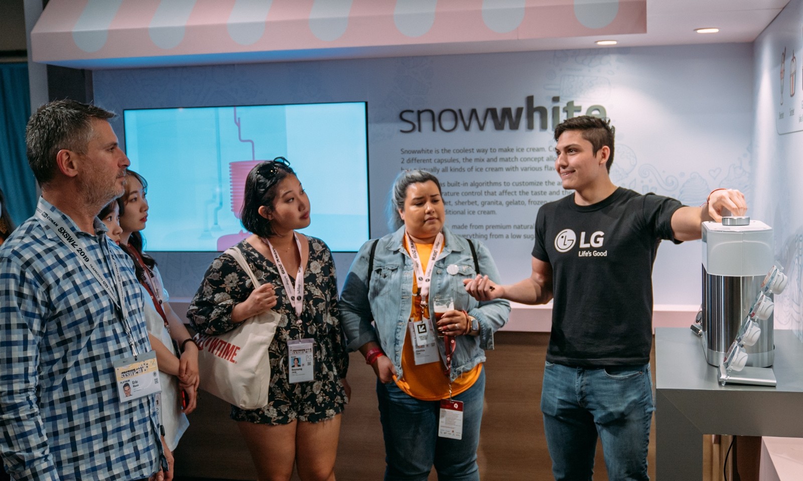 One LG staff member explains LG’s personal ice cream maker prototype, snowwhite.