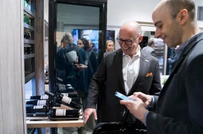 Visitors discuss the wine cellar in the ultra-luxury Signature Kitchen Suite brand.