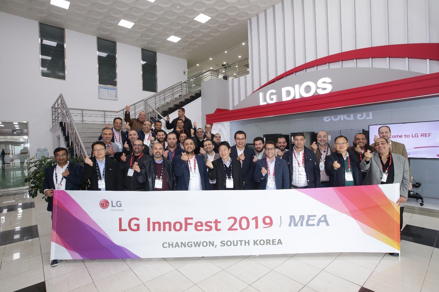 A group photo of attendees standing behind the wide LG InnoFest 2019 MEA banner