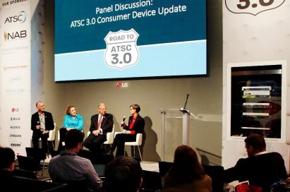 LG’s large display hangs against the wall over the podium for a panel discussion during the Road to ATSC 3.0 exhibit event.