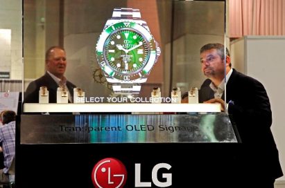 Two NAB Show attendees behold the LG Transparent OLED display which shows a piece of watch.