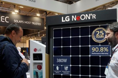 A male attendant explains the main features of LG NeON R high performance solar panel to a visitor.