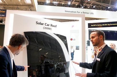 A male attendant explains the main features of LG Solar Car Roof to a visitor at its Intersolar Europe booth.