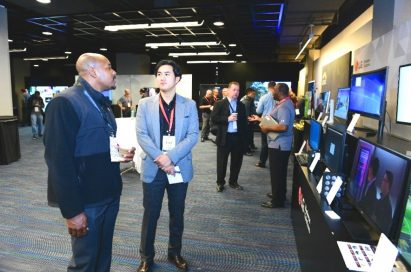 A group of attendees discuss LG’s B2B monitor solutions.