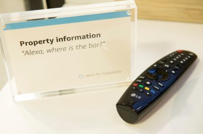 LG’s Magic Remote and a plastic information frame that informs visitors of the voice command, “Alexa, where is the bar?”