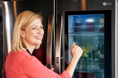 A lady in red shirts knocks on the transparent display panel of the LG InstaView Door-in-Door® refrigerator.