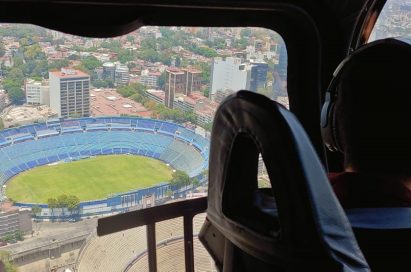 The pilot looks down to the Azul Stadium from the helicopter flying in the sky.