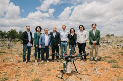 The associates of LG Smart Green project stand together behind the drone which is equipped with the LG G8S ThinQ smartphone.