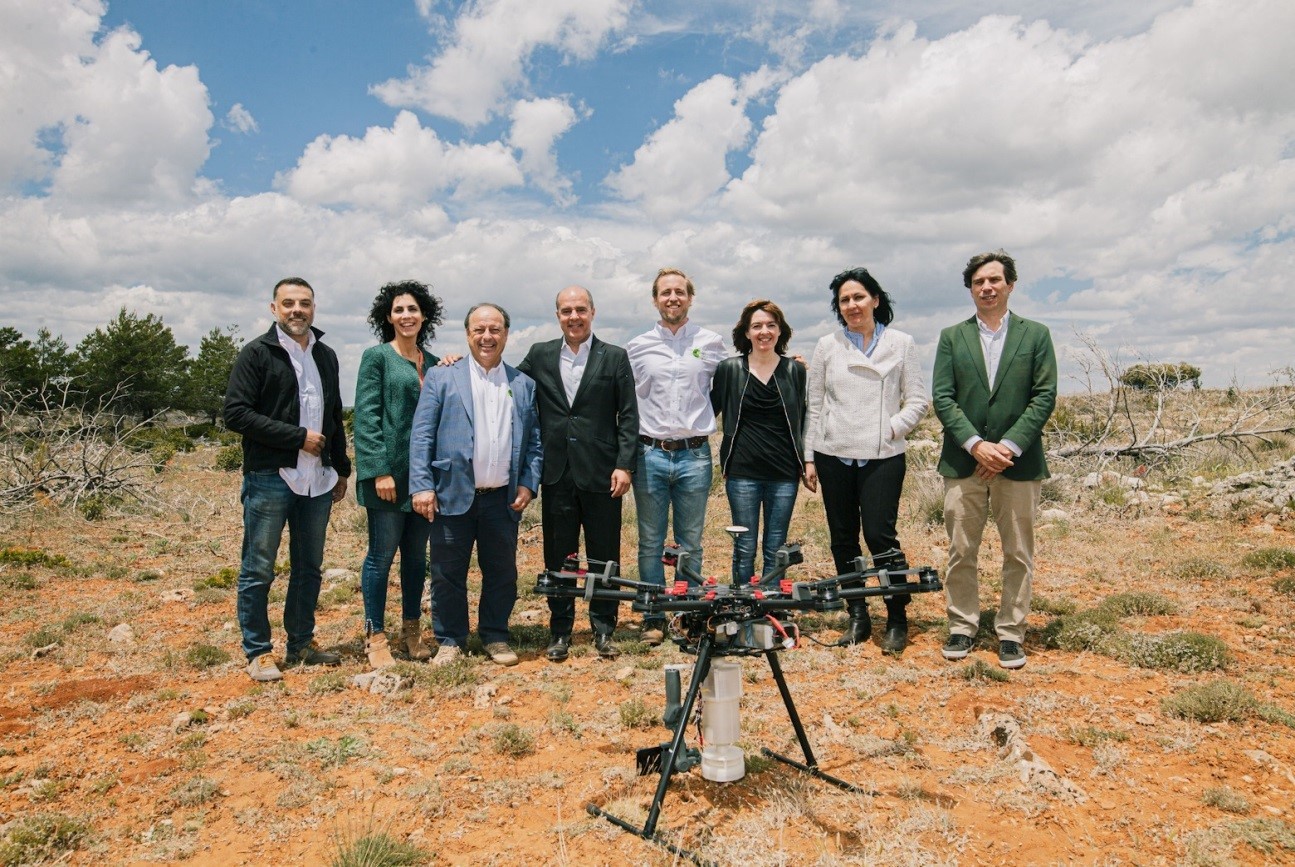 The associates of LG Smart Green project stand together behind the drone which is equipped with the LG G8S ThinQ smartphone.