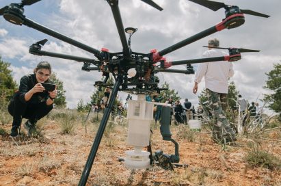 A female associate looks at the LG G8S ThinQ after detaching it from the drone.