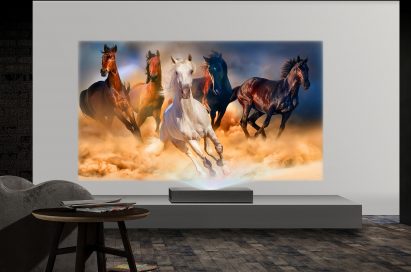 A view of LG CineBeam 4K UHD projector model HU85L producing images of running horses in a low-lit room