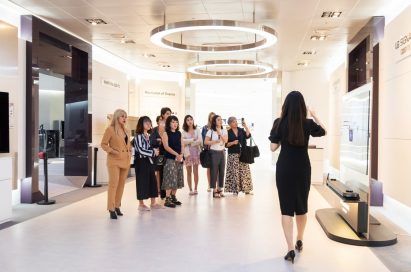 Singaporean journalists and social media influencers stand next to each other during their visit to LG’s headquarters in South Korea.