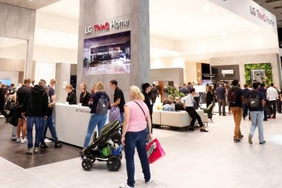 The LG ThinQ Home zone at IFA 2019 seen from a slight angle, there are many visitors looking around the booth.