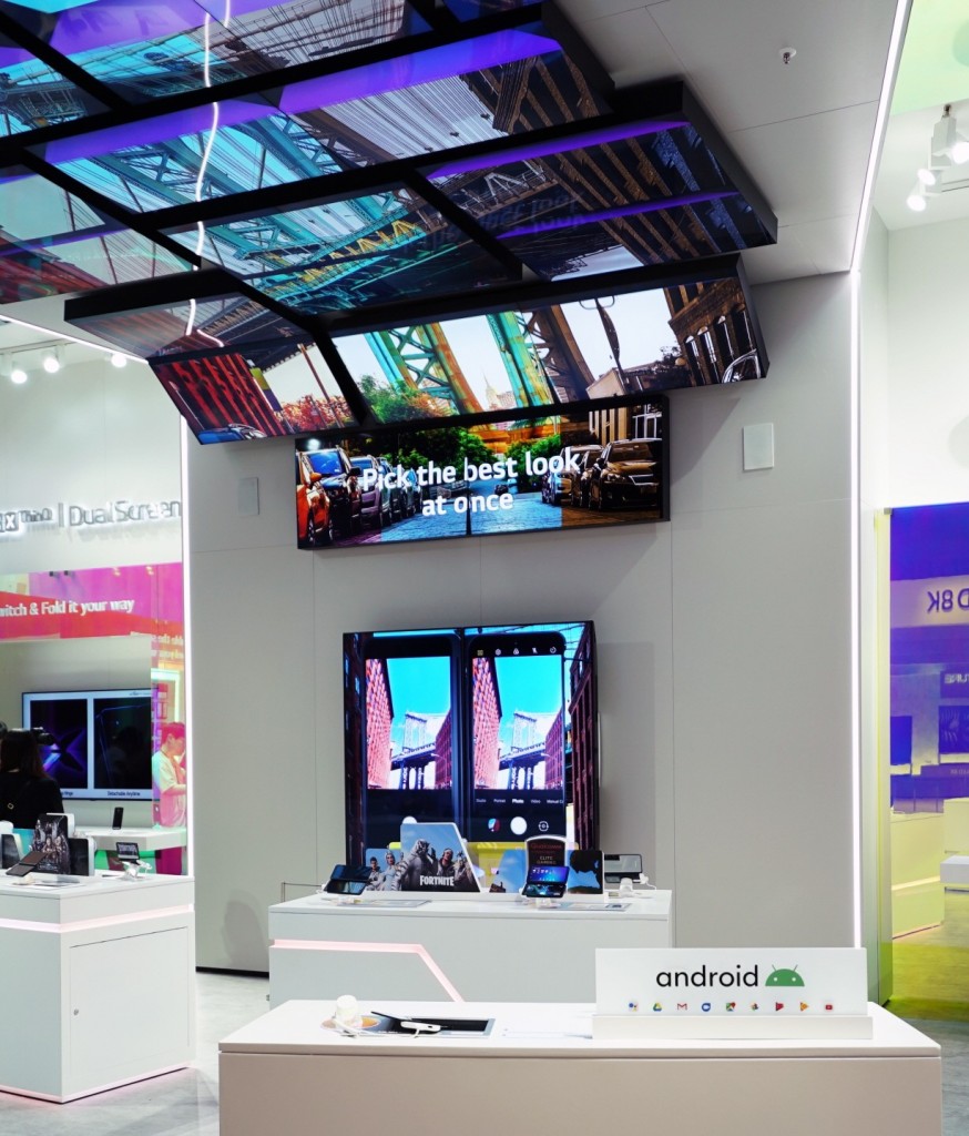 The LG G8X ThinQ zone is viewed from the other direction and the zone demonstrates the key features of LG G8X ThinQ using a number of large TV displays.