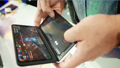 A man holds the LG G8X ThinQ Dual Screen to play a mobile game.