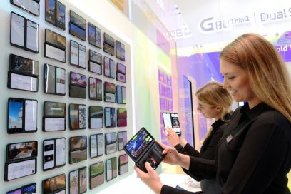 Two female models hold up the LG G8X ThinQ smartphones at LG’s IFA booth, which demonstrates all the new features of LG G8X ThinQ.