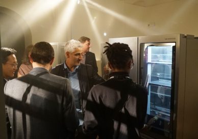 Attendees discuss the LG InstaView Door-in-Door refrigerator at LG SIGNATURE’s exhibition space.