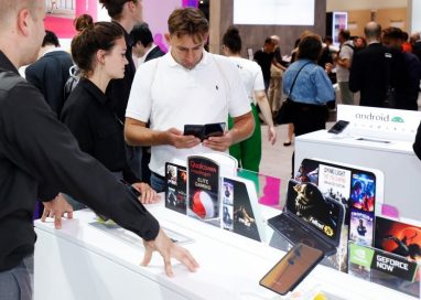 A visitor to LG MC booth looks down at the screen of the LG G8X ThinQ Dual Screen.
